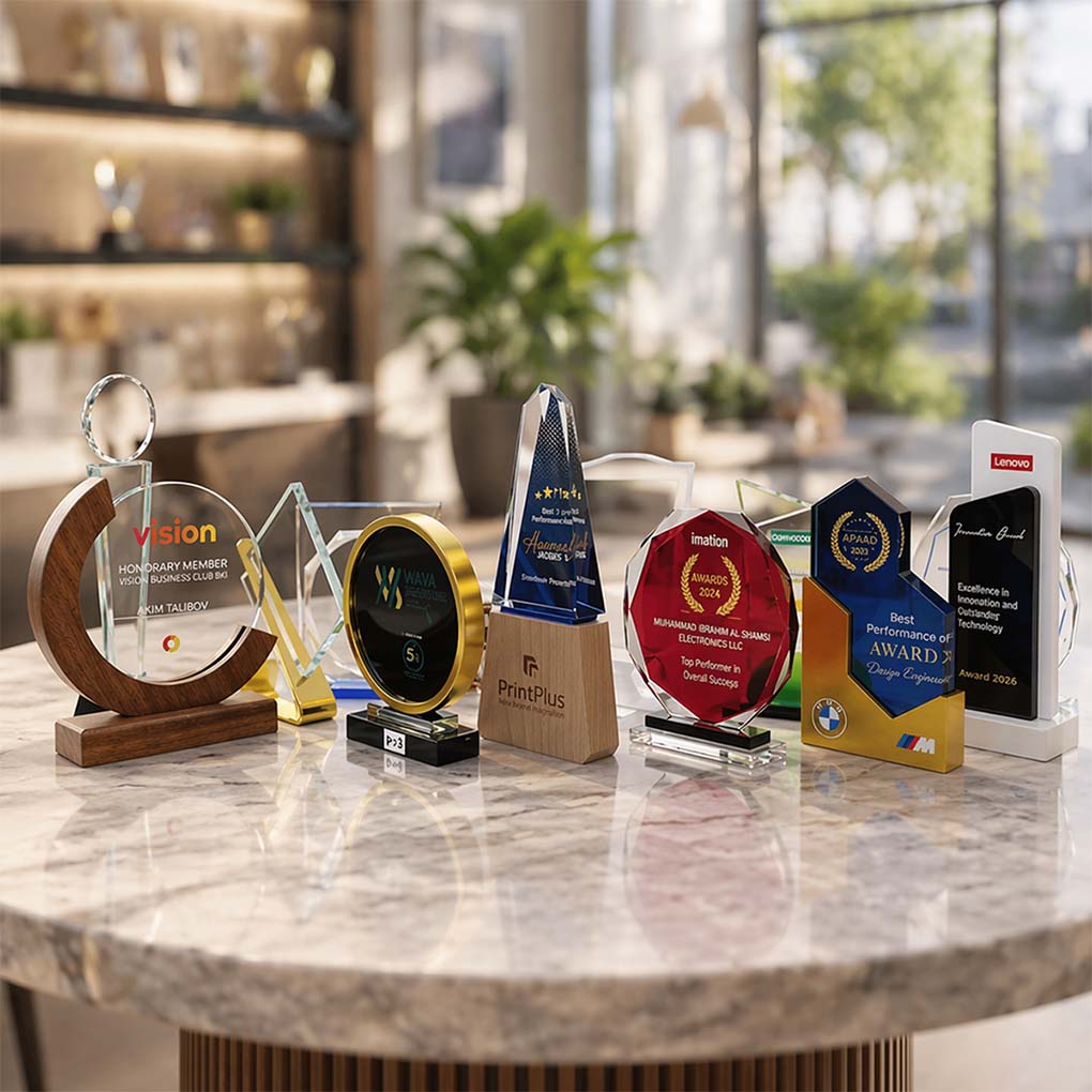 Custom acrylic and crystal awards and trophies with UV printed branding for corporate recognition in Dubai